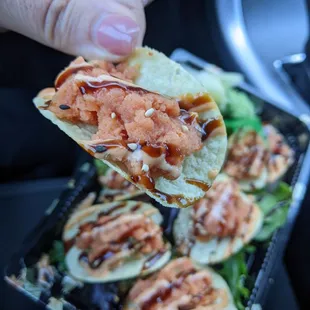  a hand holding a piece of food