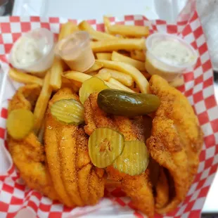 a basket of fried fish and fries