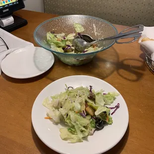 a plate of salad and a bowl of salad