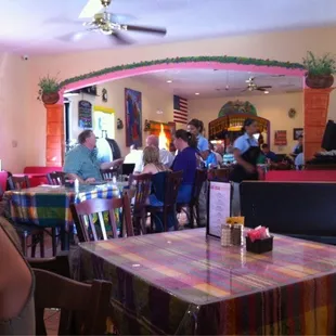 people sitting at tables in a restaurant