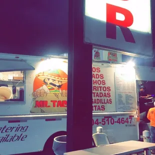 a food truck parked in front of a restaurant