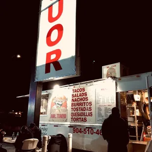 Taco truck in front of a liquor store is where you need to be!