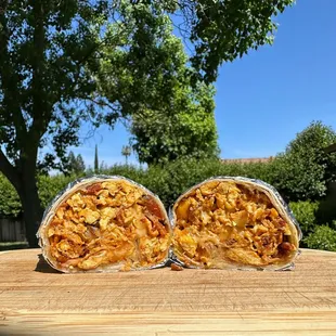 two burritos on a table