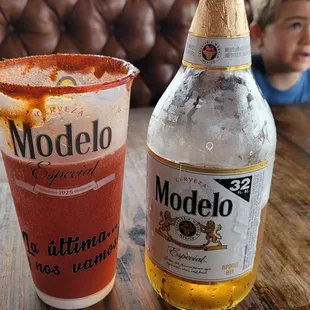  a bottle of modelo and a glass of modelo