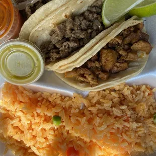 a plate of food with rice, meat, and salsa
