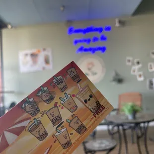 a person holding up a menu