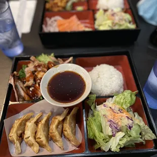 Teriyaki chicken with gyoza and sesame chicken with salmon sashimi