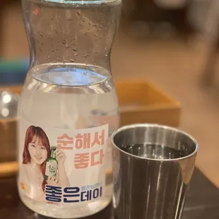 Water served in a plastic container and steal cup.