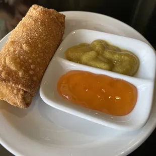 a plate of food with dipping sauces