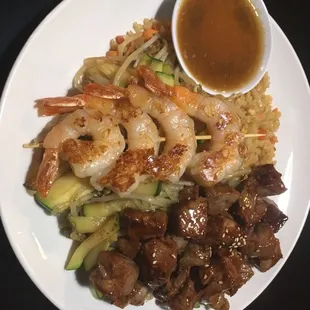 Combination plate with shrimp, steak, and fried rice