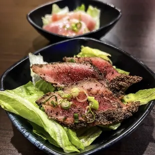 a plate of steak and lettuce