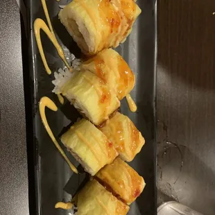 a plate of sushi with sauce