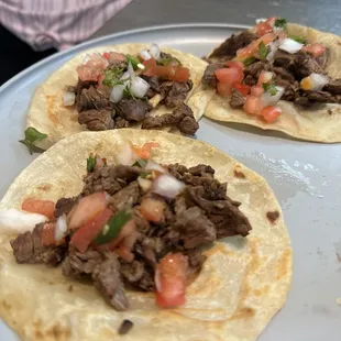marinated carne asada. they marinated it. they grilled it. they cut it. i just put some dank ass pico on it, that i also got from them.