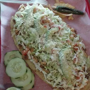 a hot dog with coleslaw and pickles