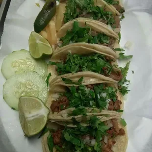 a plate of tacos and a pickle