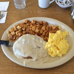 Chicken fried steak with scrambled eggs and country potatoes!