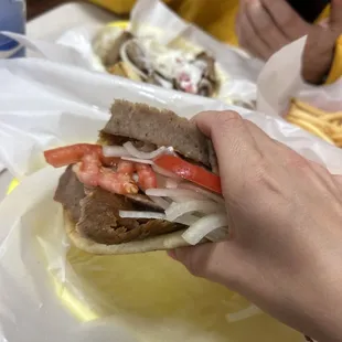 a person taking a picture of a sandwich