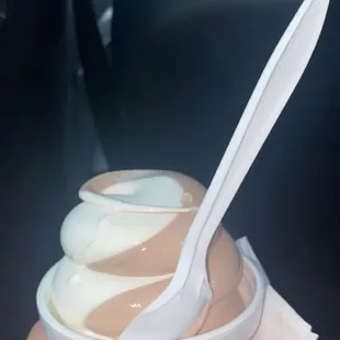 a hand holding a cup of ice cream