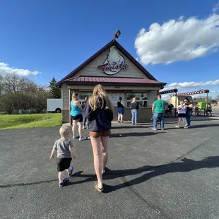 a woman and a child in front of a restaurant