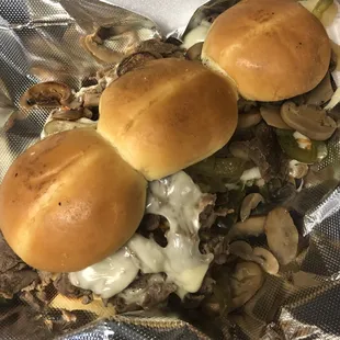 Philly cheesesteak loaded with onions, peppers, and mushrooms
