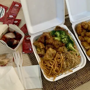 two take out containers of food on a table