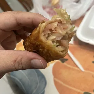 a person holding a piece of food