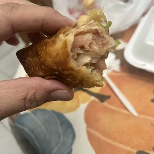 a person holding a sandwich