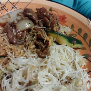 a plate of noodles and meat