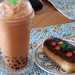 Thai tea boba and M &amp; M doughnut.