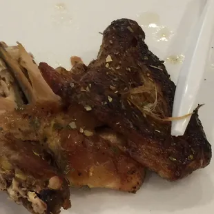 Piece of Greek chicken with feathers.WTF