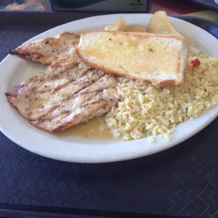 Grilled chicken Dinner potatoes rice pilaf and garlic bread