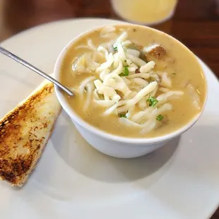 a bowl of soup and a piece of toast