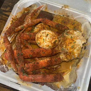 Crab legs, eggs, sausage, and corn