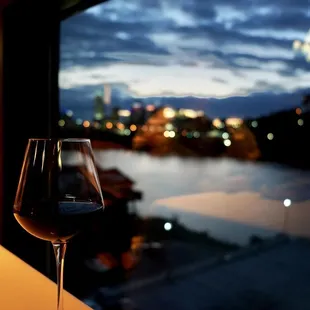 a glass of wine sitting on a table
