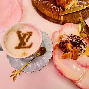 Signiture cappuccino and croissants from their pastry basket.