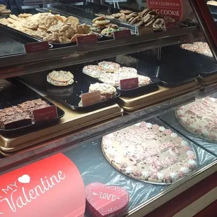 a display case filled with cakes and pastries