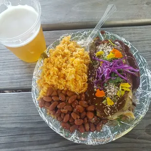 Delicious tamale with mole garnished with edible flowers