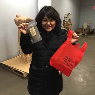 a woman holding a bag of tea