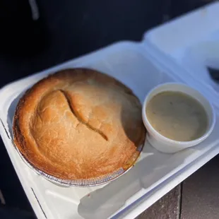 a pie with a side of sauce