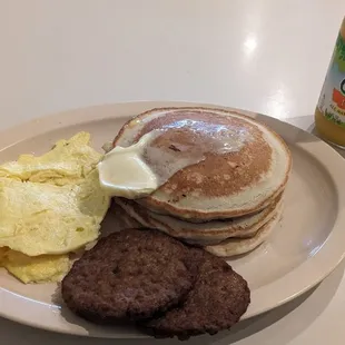 Pancakes and sausage w/scrambled eggs w/cheese.