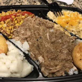 Smothered chicken on rice with extra side, mashed potatoes, corn, mac'n'cheese, cornbread, that gravy on the chicken was ridiculous
