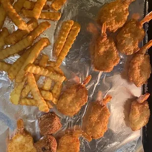 a tray of fried shrimp and fries