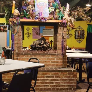 tables and chairs in front of a fireplace