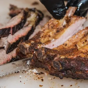 a person cutting up meat