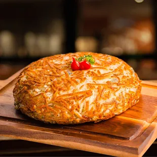 a closeup of a baked potato on a cutting board