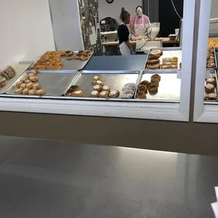 a woman working in a donut shop