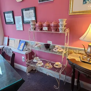 a pink room with a table and chairs