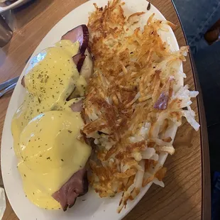 Eggs Benedict and crispy hash browns.