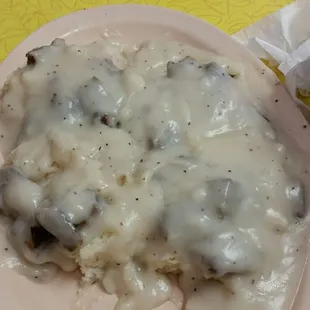 Two biscuits with sausage and gravy