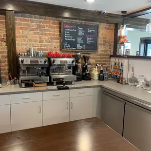 a coffee bar with a brick wall
